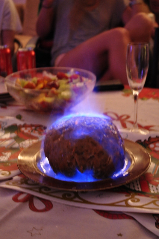 Traditional christmas pudding served flaming