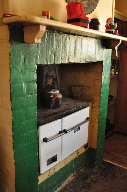 Old woodstove in a brick fireplace - makes fabulous rabbit stew simmering all day in the back corner